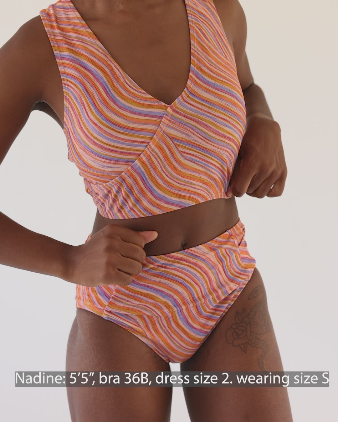 Video showing a girl wearing a retro pink, blue, purple and orange wave Yoga Pocket Bottom