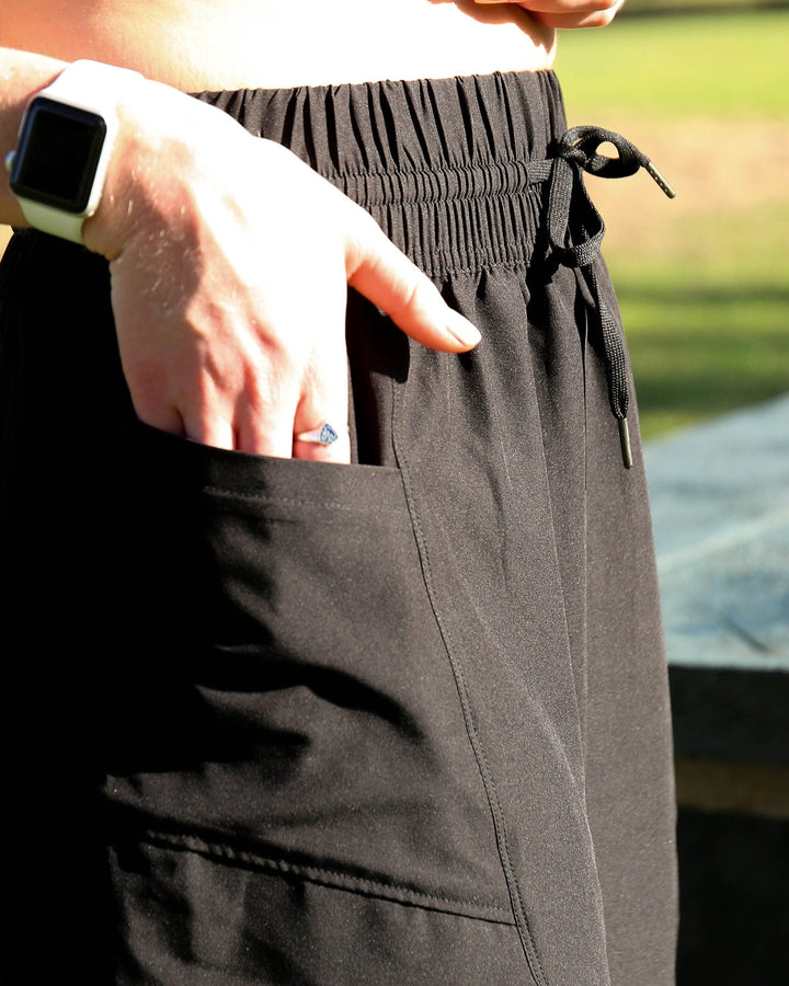 A picture of a black athletic skirt with a pocket detail.