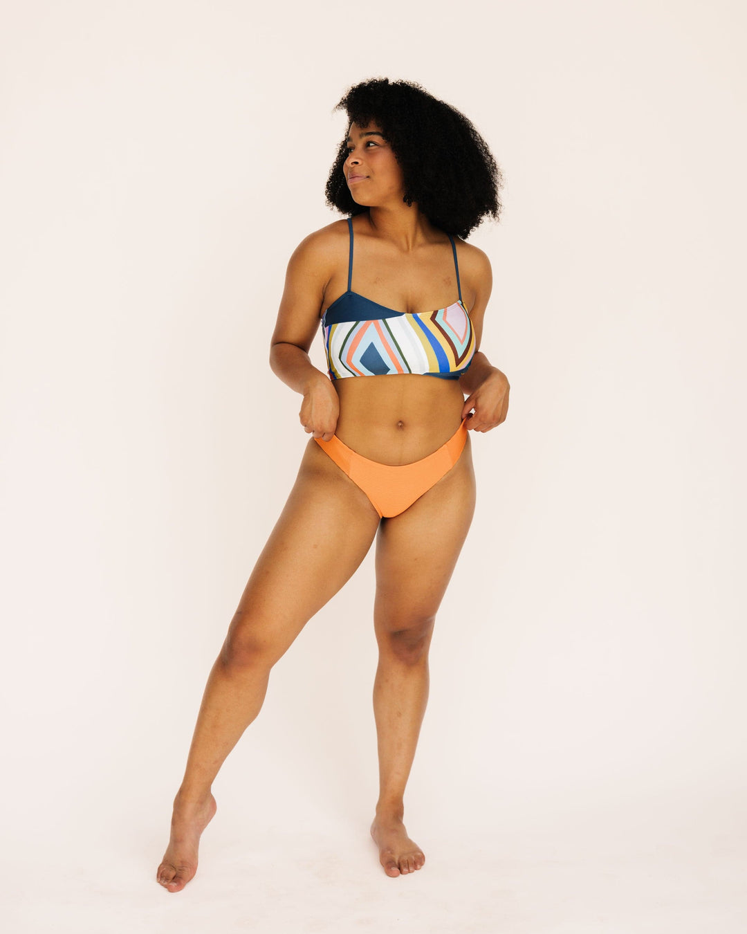 Full body Front view Studio picture of a girl wearing textured orange bikini bottoms