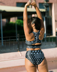 Women wearing a supportive black and white floral two piece swimsuit.