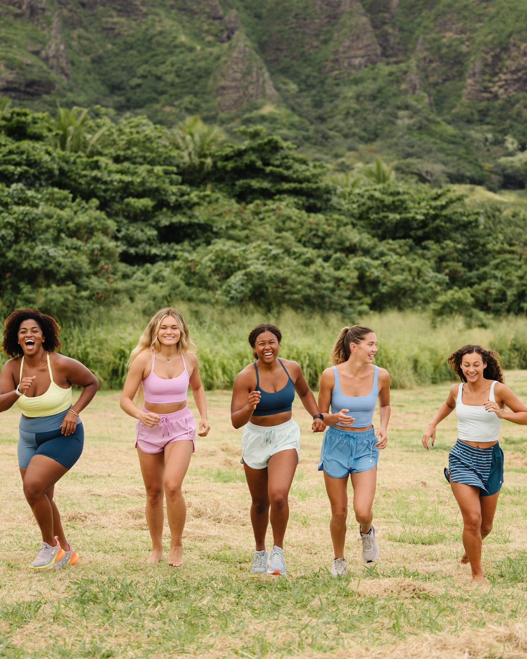 A group of women running together in athletic clothing.