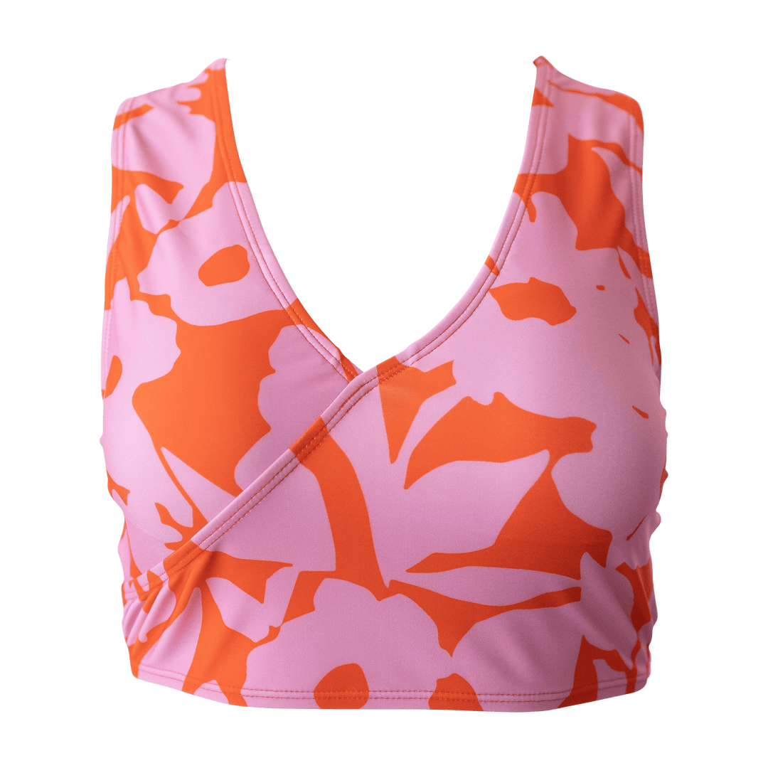 A flat lay image of a pink and red floral v neck bikini top.